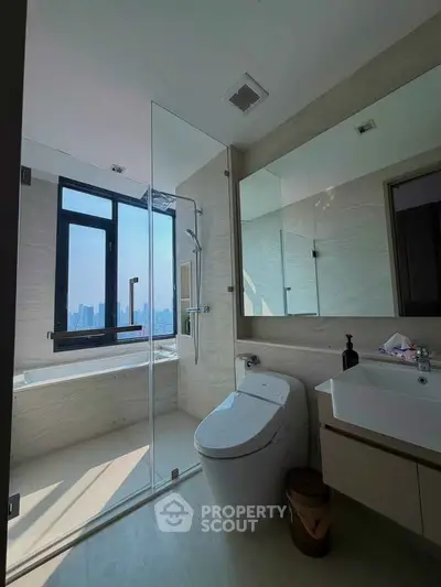 Luxurious bathroom with city view, featuring modern fixtures and a glass-enclosed shower.