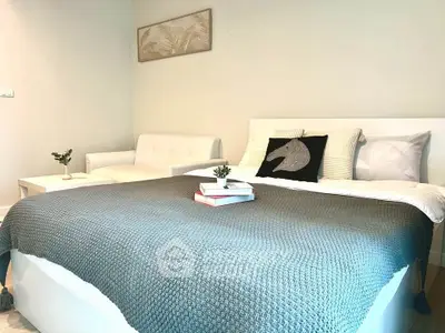 Cozy bedroom with stylish decor and comfortable bedding