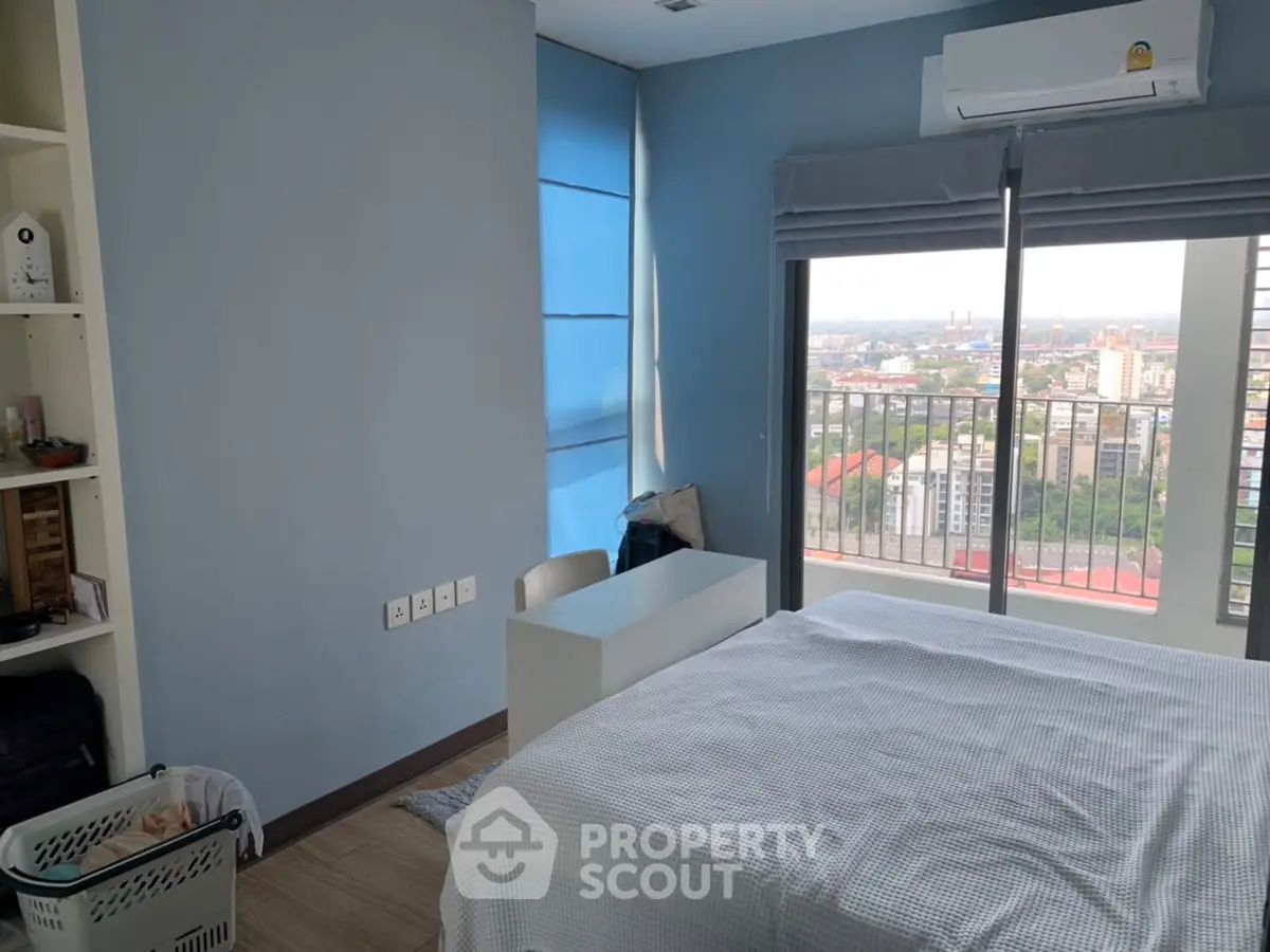 Modern bedroom with city view and balcony access
