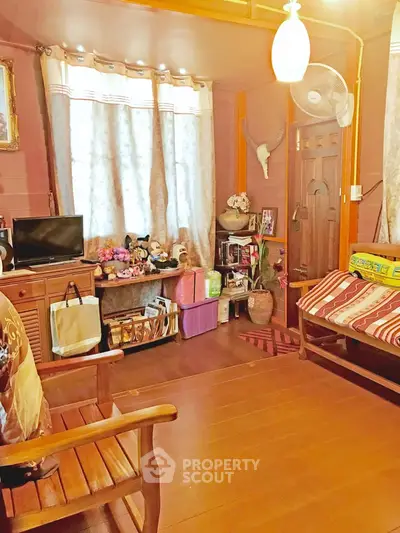 Cozy living room with wooden furniture and warm lighting, perfect for relaxation and family gatherings.