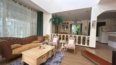 Charming living room with vintage furniture and open layout, perfect for cozy gatherings.