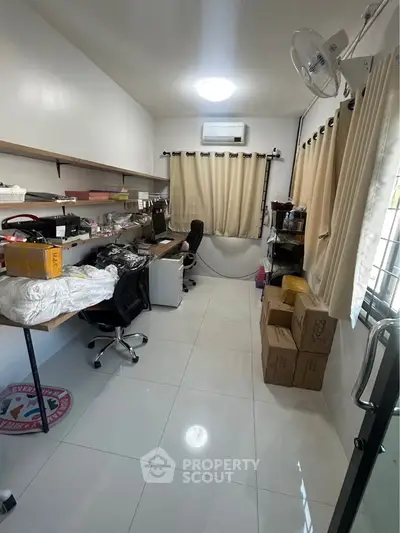 Spacious study room with modern furniture and ample storage space.