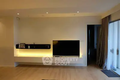 Modern living room with sleek TV setup and ambient lighting