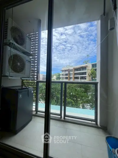 Charming balcony view with lush greenery and cityscape, perfect for relaxation.