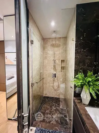 Luxurious bathroom with elegant marble tiles and modern fixtures in a high-end apartment.