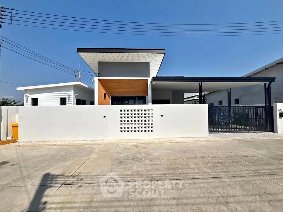 Modern single-story house with sleek facade and gated entrance