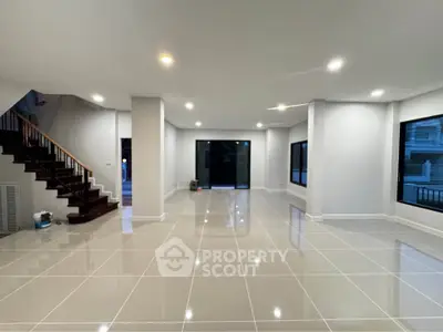 Spacious modern living room with glossy tiled floors and large windows
