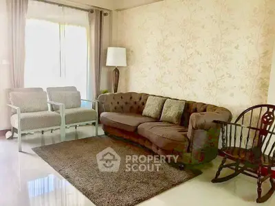 Charming living room with elegant sofa and cozy armchairs, perfect for relaxation.