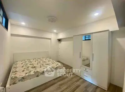 Spacious bedroom with modern furnishings and ample natural light