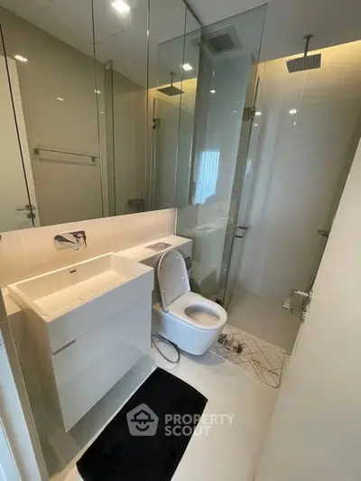 Modern bathroom with glass shower and sleek fixtures