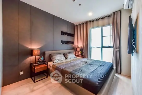 Modern bedroom with stylish decor and large window for natural light