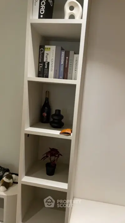 Modern interior with stylish bookshelf and decorative items in a cozy living space.