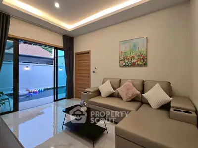 Modern living room with pool view, featuring elegant decor and comfortable seating.