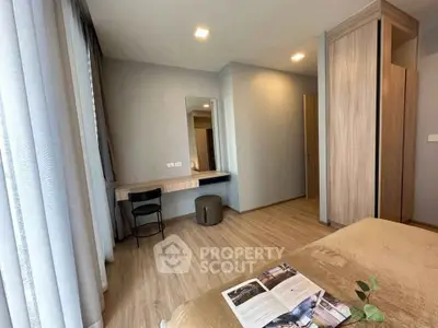 Spacious bedroom with modern decor and natural light