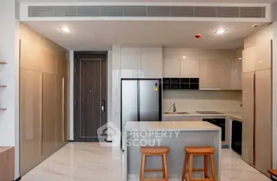 Modern kitchen with sleek cabinetry and island in luxury apartment
