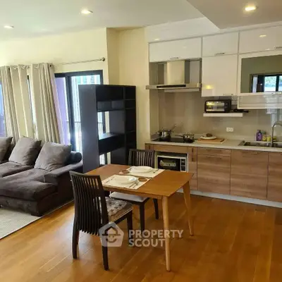 Modern open-plan living room with cozy sofa and stylish kitchen area