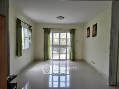 Spacious empty living room with large windows and tiled floor, perfect for customization.