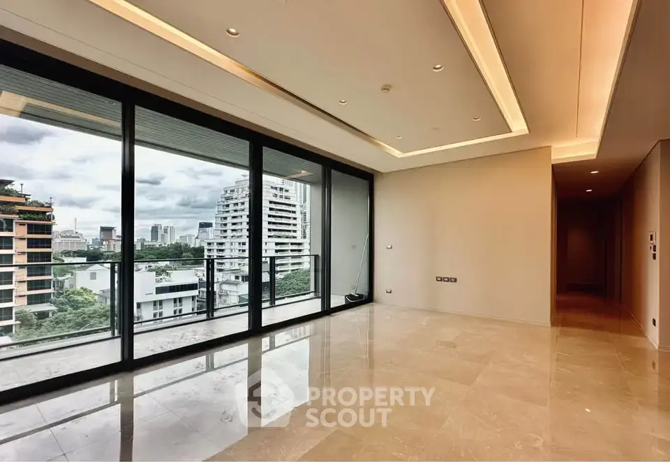 Spacious modern living room with floor-to-ceiling windows offering stunning city views.