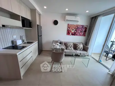 Modern living room with open kitchen, stylish decor, and balcony access in a contemporary apartment.