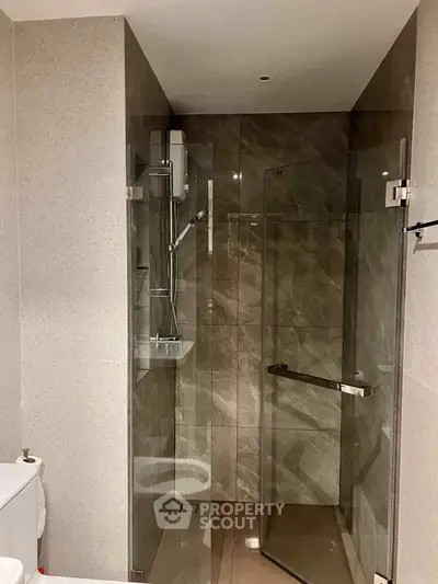 Modern bathroom with glass shower enclosure and sleek design