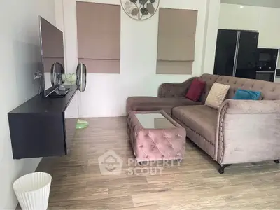 Stylish living room with plush sofa and modern decor in a cozy apartment setting.