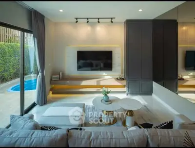 Luxurious living room with modern decor and pool view