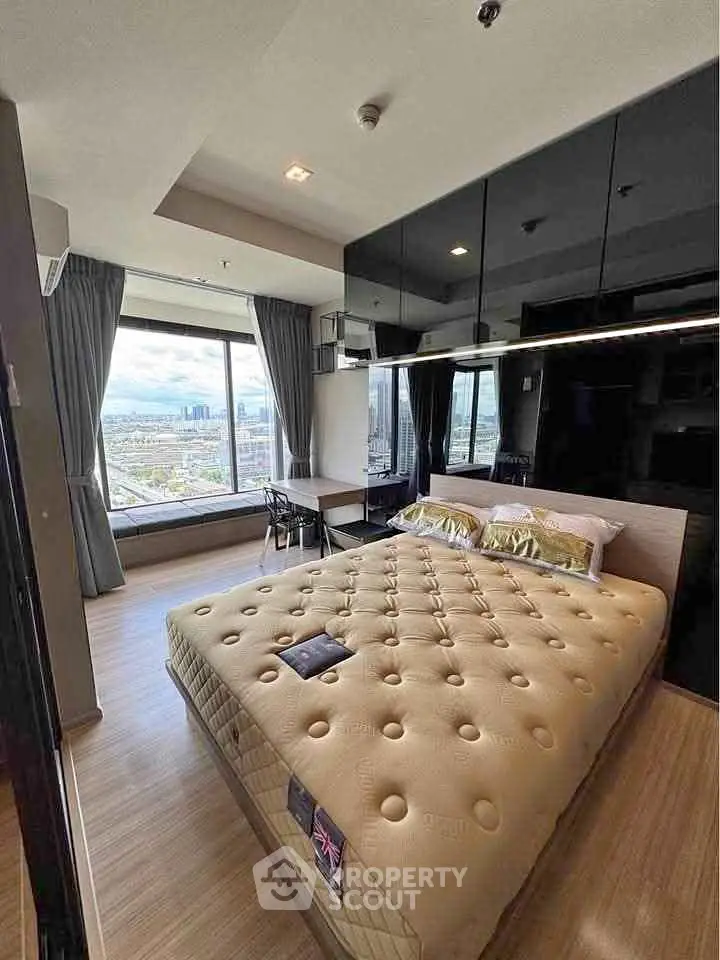 Modern bedroom with large window offering stunning city view, featuring sleek design and cozy ambiance.