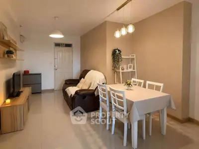 Cozy living room with dining area, modern decor, and warm lighting in a stylish apartment.