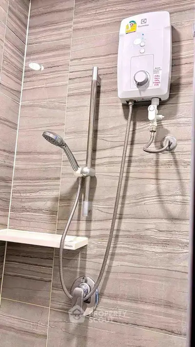 Modern bathroom with sleek shower and water heater, featuring elegant tile design.