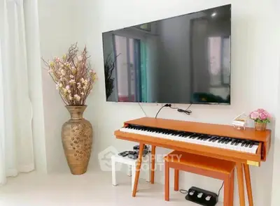 Stylish living room with modern TV and elegant piano setup, perfect for entertainment and relaxation.