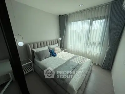 Modern bedroom with elegant decor and large window for natural light