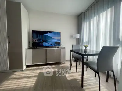 Modern living room with sleek furniture and large window for natural light.