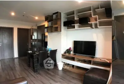 Modern living room with stylish shelving and sleek furniture in a contemporary apartment.