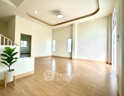Spacious modern living room with elegant ceiling design and natural light