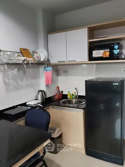 Compact kitchen with modern appliances and sleek cabinetry