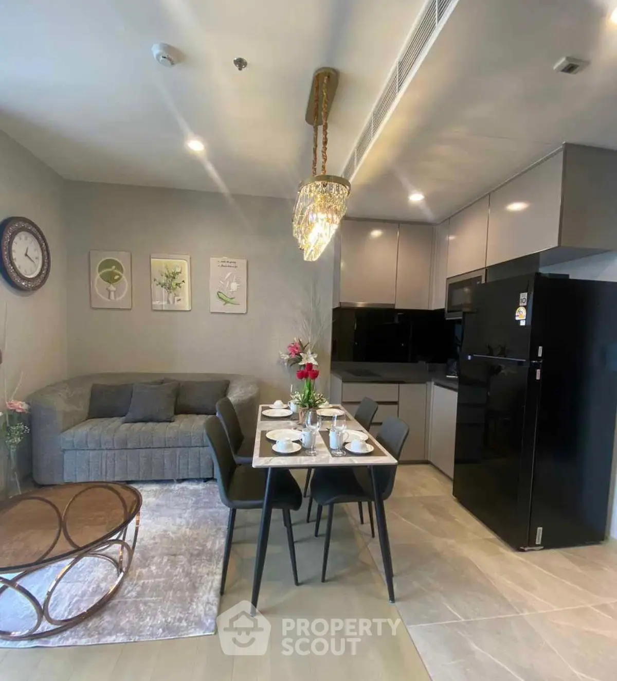 Modern open-layout kitchen and living room with elegant decor and dining setup.