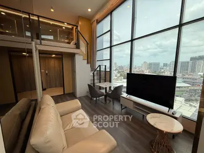 Modern loft apartment with large windows and city view
