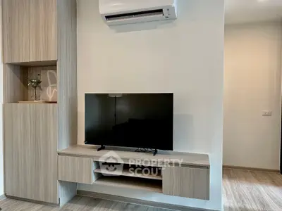 Modern living room with sleek TV stand and air conditioning unit, perfect for comfortable living.