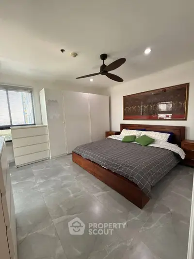 Spacious modern bedroom with stylish decor and large bed