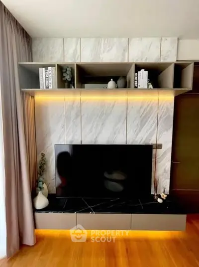 Modern living room with stylish TV unit and ambient lighting