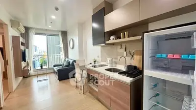 Modern open-layout kitchen and living area with city view balcony.