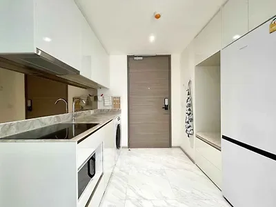 Modern kitchen with sleek appliances and marble countertops in a stylish apartment.
