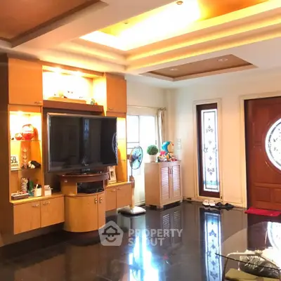Spacious living room with modern entertainment center and elegant lighting