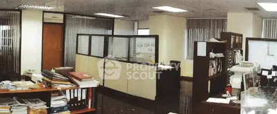Spacious office interior with cubicles and organized workstations, ideal for a productive business environment.
