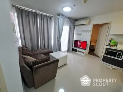 Modern living room with cozy brown sofa, sleek TV setup, and natural light from large windows.