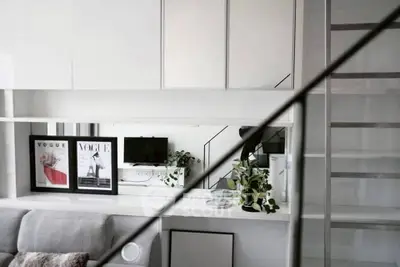 Modern living room with sleek design and stylish decor, featuring a cozy sofa and elegant shelving.