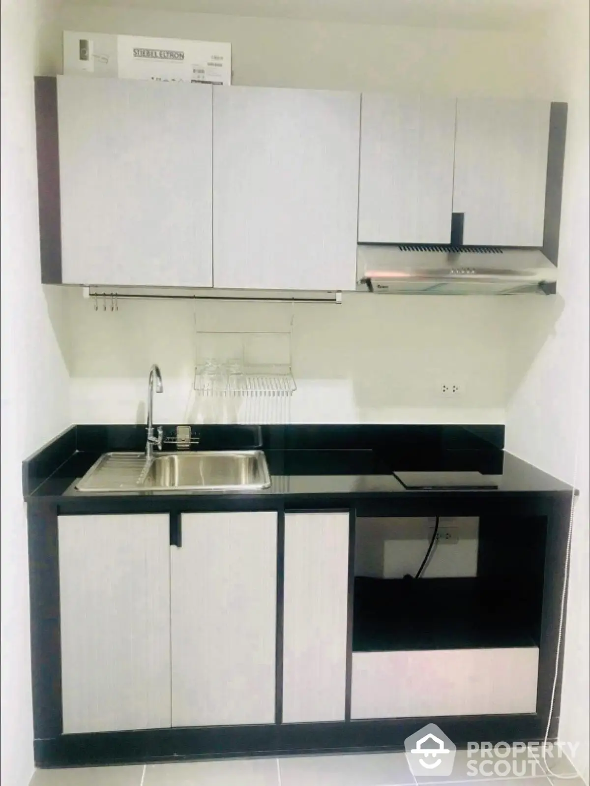 Modern compact kitchen with sleek cabinetry and stainless steel sink