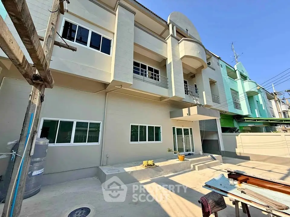 Modern townhouse exterior with clean lines and large windows, perfect for urban living.