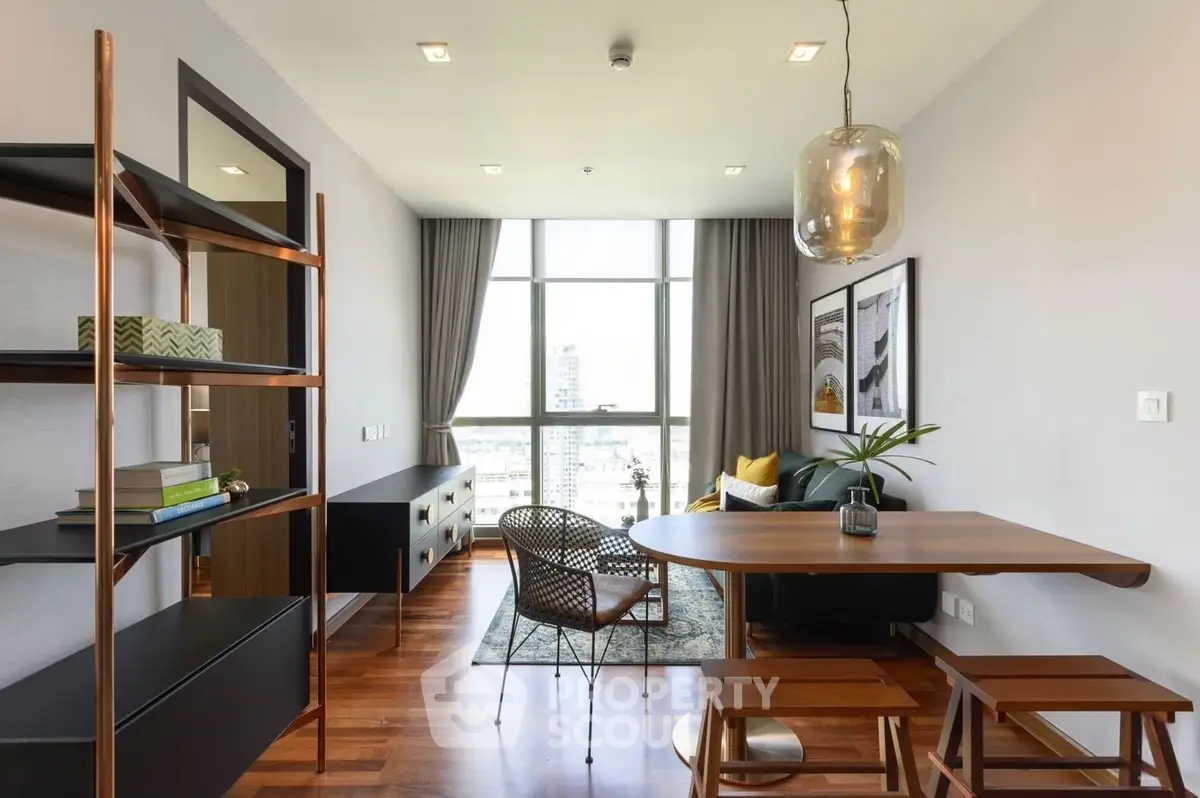 Modern living room with stylish furniture and large window offering city view