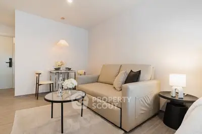 Modern living room with beige sofa, stylish decor, and cozy lighting